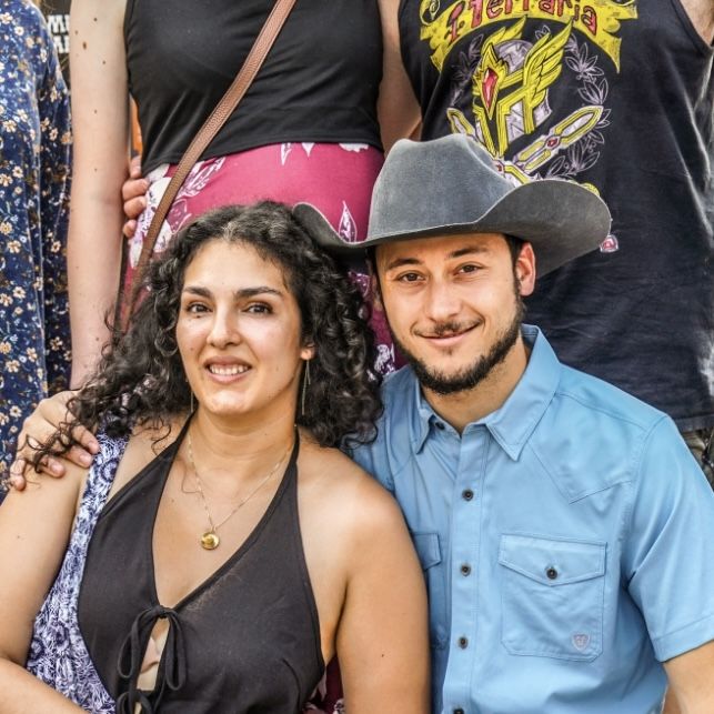 Ileana and Tristan in a cowboy hat with friends
