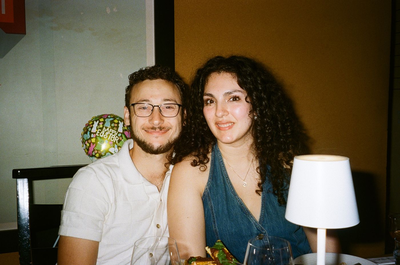 Tristan and Ileana smiling together at a dinner table