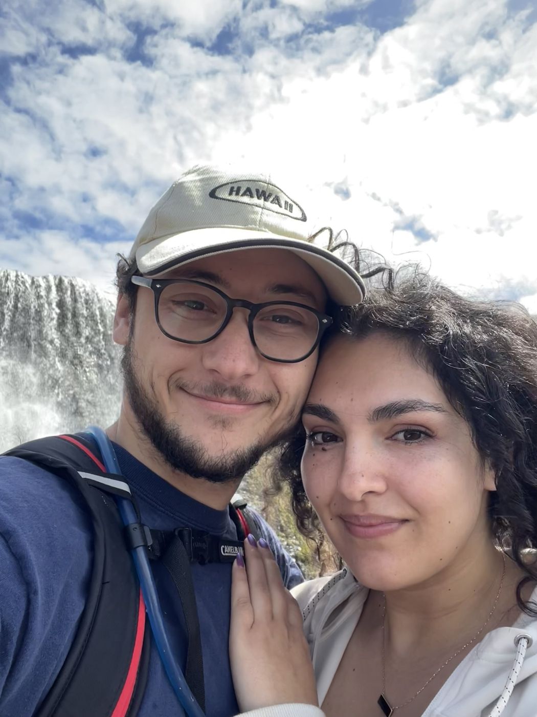 Tristan and Ileana in front of a waterfall